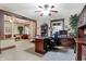 Comfortable home office featuring a wooden desk, chair, bookcase, and ample natural light at 2023 Shelby St, Indianapolis, IN 46203