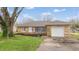 Charming single Gathering home featuring a stone facade, attached garage, and well-maintained front yard at 220 Monroe St, Indianapolis, IN 46229