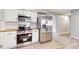 Modern kitchen with stainless steel appliances, bright white cabinetry, and wood countertops at 220 Monroe St, Indianapolis, IN 46229