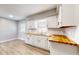 Clean and bright kitchen with white cabinets, wood countertops, and tile backsplash at 220 Monroe St, Indianapolis, IN 46229