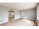Cozy living room with wood floors, neutral walls, and an open archway to the kitchen at 220 Monroe St, Indianapolis, IN 46229
