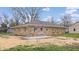 View of the rear exterior of the home featuring a concrete patio and newly landscaped yard at 220 Monroe St, Indianapolis, IN 46229