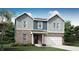 Charming two-story home with a brick and siding facade and a two-car garage at 2232 Foothill Dr, Greenfield, IN 46140