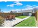 Well-maintained backyard featuring a cozy patio, green lawn, and detached garage at 2352 N College Ave, Indianapolis, IN 46205