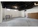 Unfinished basement with concrete floor, exposed ceiling, and small windows at 2352 N College Ave, Indianapolis, IN 46205