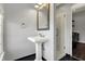 Bathroom featuring pedestal sink, tiled floor, framed mirror, and glass shower stall at 2352 N College Ave, Indianapolis, IN 46205