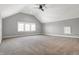 Spacious bedroom features vaulted ceilings, a ceiling fan, and a large picture window at 2352 N College Ave, Indianapolis, IN 46205