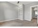 This bedroom features carpet, built-in shelving and a view to the hallway at 2352 N College Ave, Indianapolis, IN 46205