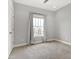 Bedroom featuring neutral carpet, a bright window with coverings and a closet at 2352 N College Ave, Indianapolis, IN 46205