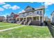 Charming home exterior with well-manicured lawn, inviting porches, and craftsman details at 2352 N College Ave, Indianapolis, IN 46205