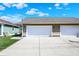 Spacious three-car garage with white doors and a wide driveway for easy access and parking at 2352 N College Ave, Indianapolis, IN 46205