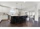 Kitchen with a black island and seating, stainless steel appliances, and white subway tile backsplash at 2352 N College Ave, Indianapolis, IN 46205