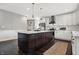 Modern kitchen featuring a large island with seating, stainless steel appliances, and white cabinetry at 2352 N College Ave, Indianapolis, IN 46205