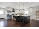 Modern kitchen features a large center island, stainless steel appliances, and stylish pendant lighting at 2352 N College Ave, Indianapolis, IN 46205