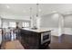 Open kitchen with a large center island featuring seating, and connection to the other living spaces at 2352 N College Ave, Indianapolis, IN 46205