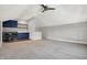 Spacious laundry room features blue cabinets, open shelving, washer and dryer, and ceiling fan at 2352 N College Ave, Indianapolis, IN 46205