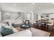 Bright and airy living space with hardwood floors, a neutral palette, and an open layout to the kitchen at 2352 N College Ave, Indianapolis, IN 46205