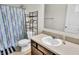 Bathroom featuring a sink, toilet, shower with curtain, and ample lighting at 2468 Shadow Bend Dr, Columbus, IN 47201
