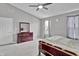 Bedroom with neutral walls, ceiling fan, large bed, and window with natural light at 2468 Shadow Bend Dr, Columbus, IN 47201