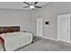 Bedroom featuring neutral walls, ceiling fan, and closet access at 2468 Shadow Bend Dr, Columbus, IN 47201