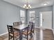 Cozy dining room with hardwood floors, chandelier, and view of front yard through bright windows at 2468 Shadow Bend Dr, Columbus, IN 47201