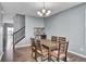 Bright dining area with hardwood floors, a decorative chandelier, and ample space for Gathering gatherings at 2468 Shadow Bend Dr, Columbus, IN 47201