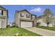 Inviting two-story home boasts a two-car garage, brick accents, and tidy landscaping under a partly cloudy sky at 2468 Shadow Bend Dr, Columbus, IN 47201