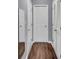 Hallway with hardwood floors and multiple entryways, offering easy access to various rooms at 2468 Shadow Bend Dr, Columbus, IN 47201