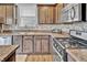 Stylish kitchen featuring tile backsplash, stainless steel appliances and wood floors at 2468 Shadow Bend Dr, Columbus, IN 47201