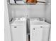 Functional laundry room with a neatly arranged shelf and modern white Maytag washer and dryer units at 2468 Shadow Bend Dr, Columbus, IN 47201