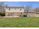 Large backyard featuring a deck, dining table, grill, and mature trees at 2539 S Edgewood Cv, Martinsville, IN 46151