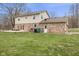 Spacious backyard featuring a deck, dining table, grill, and mature trees at 2539 S Edgewood Cv, Martinsville, IN 46151