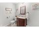 Well-maintained bathroom with wooden vanity, decorative mirror, and light fixtures at 2539 S Edgewood Cv, Martinsville, IN 46151