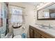 Bright bathroom features marble countertop, wooden cabinets, and a charming window at 2539 S Edgewood Cv, Martinsville, IN 46151