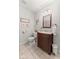 Cozy bathroom with wooden vanity, decorative mirror, and neutral wall color at 2539 S Edgewood Cv, Martinsville, IN 46151