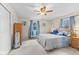 Comfortable bedroom with a wooden bed frame, blue accents, and soft carpeting at 2539 S Edgewood Cv, Martinsville, IN 46151