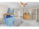 Bright bedroom features a wooden bed frame, natural light, and neutral carpeting at 2539 S Edgewood Cv, Martinsville, IN 46151