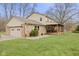 View of home and backyard, featuring large, covered patio and attached two-car garage at 2539 S Edgewood Cv, Martinsville, IN 46151