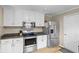 Functional kitchen features stainless steel appliances, granite countertops, and white cabinets at 2539 S Edgewood Cv, Martinsville, IN 46151