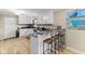 Bright kitchen with granite countertops, white cabinetry, and a breakfast bar with seating at 2539 S Edgewood Cv, Martinsville, IN 46151
