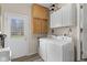 Bright laundry room featuring a washer, dryer, neutral walls and cabinets at 2539 S Edgewood Cv, Martinsville, IN 46151