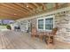 Comfortable covered patio with chairs and a welcome sign for relaxing and enjoying the outdoors at 2539 S Edgewood Cv, Martinsville, IN 46151
