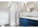 Bathroom with a glass enclosed shower, vanity with sink, white subway tile, and a mirror at 2748 Carrollton Ave, Indianapolis, IN 46205
