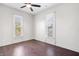 Bedroom features hardwood floors, a ceiling fan, and two windows for ample natural light at 2748 Carrollton Ave, Indianapolis, IN 46205