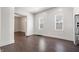 Spacious, empty room with hardwood floors, white walls, and natural light from multiple windows at 2748 Carrollton Ave, Indianapolis, IN 46205