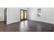 Bright, empty room with hardwood floors and double glass doors leading to the backyard at 2748 Carrollton Ave, Indianapolis, IN 46205