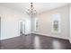 Spacious room with hardwood floors, natural light, classic chandelier and pocket door to a powder room at 2748 Carrollton Ave, Indianapolis, IN 46205