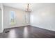 Large, airy room with hardwood floors, two large windows, and a classic chandelier at 2748 Carrollton Ave, Indianapolis, IN 46205