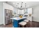Modern kitchen features white cabinets, stainless steel appliances, and a blue island at 2748 Carrollton Ave, Indianapolis, IN 46205