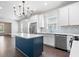 Bright kitchen showcasing a central island, stainless steel appliances, and white cabinetry at 2748 Carrollton Ave, Indianapolis, IN 46205